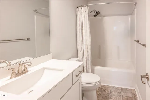 a spacious bedroom with a bed and a large window