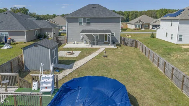 an aerial view of residential houses with outdoor space