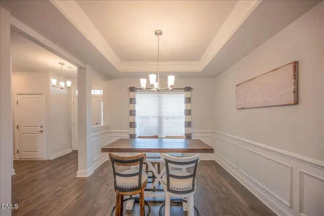 a view of a house with a swimming pool and a yard