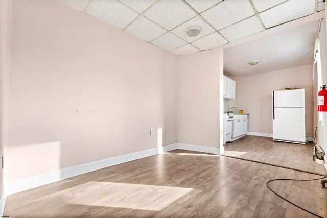 wooden floor in an empty room with a kitchen
