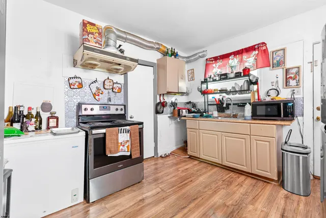 a kitchen with stainless steel appliances granite countertop a stove and a refrigerator