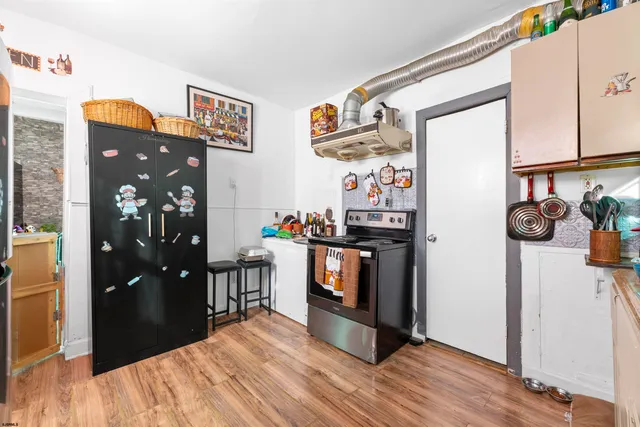 a kitchen with stainless steel appliances granite countertop a refrigerator and a stove top oven