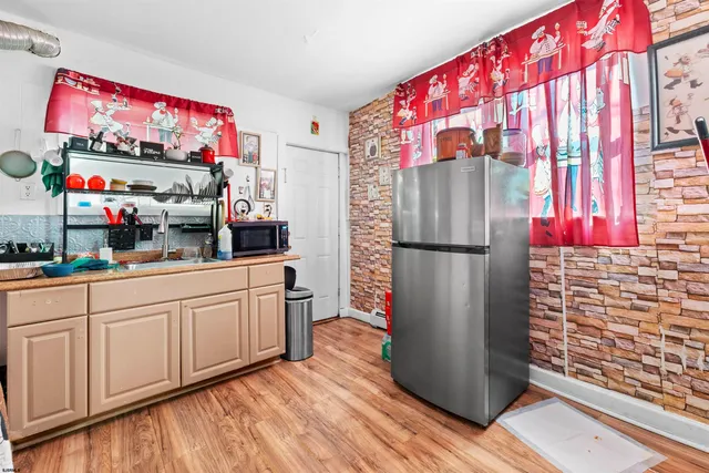 a kitchen with stainless steel appliances granite countertop a refrigerator and a sink