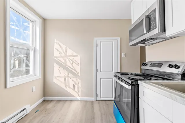 a kitchen with stainless steel appliances granite countertop a stove and a microwave