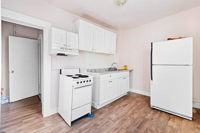 a view of a hallway with closet and wooden floor