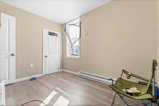 a view of room with hardwood floor and lounge chair