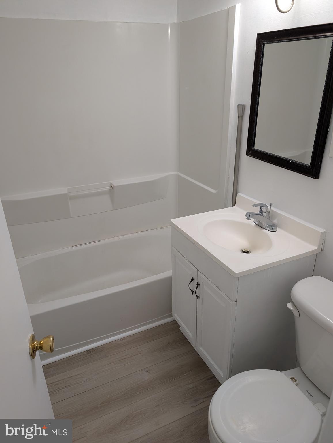 11402 Cherry Hill Road, Unit 103 Beltsville, MD 20705 - Photo 14 of 26 a bathroom with a sink a toilet and shower
