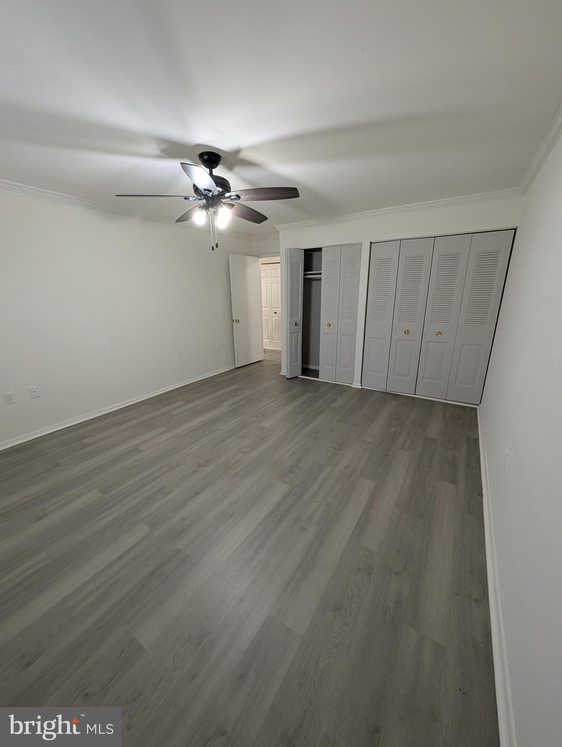 11402 Cherry Hill Road, Unit 103 Beltsville, MD 20705 - Photo 22 of 26 wooden floor in an empty room with a window