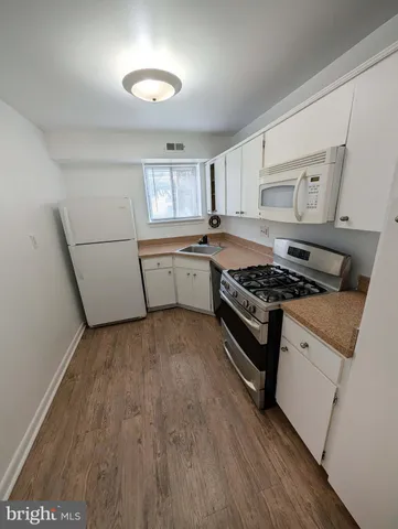 a kitchen with a stove a sink and a refrigerator