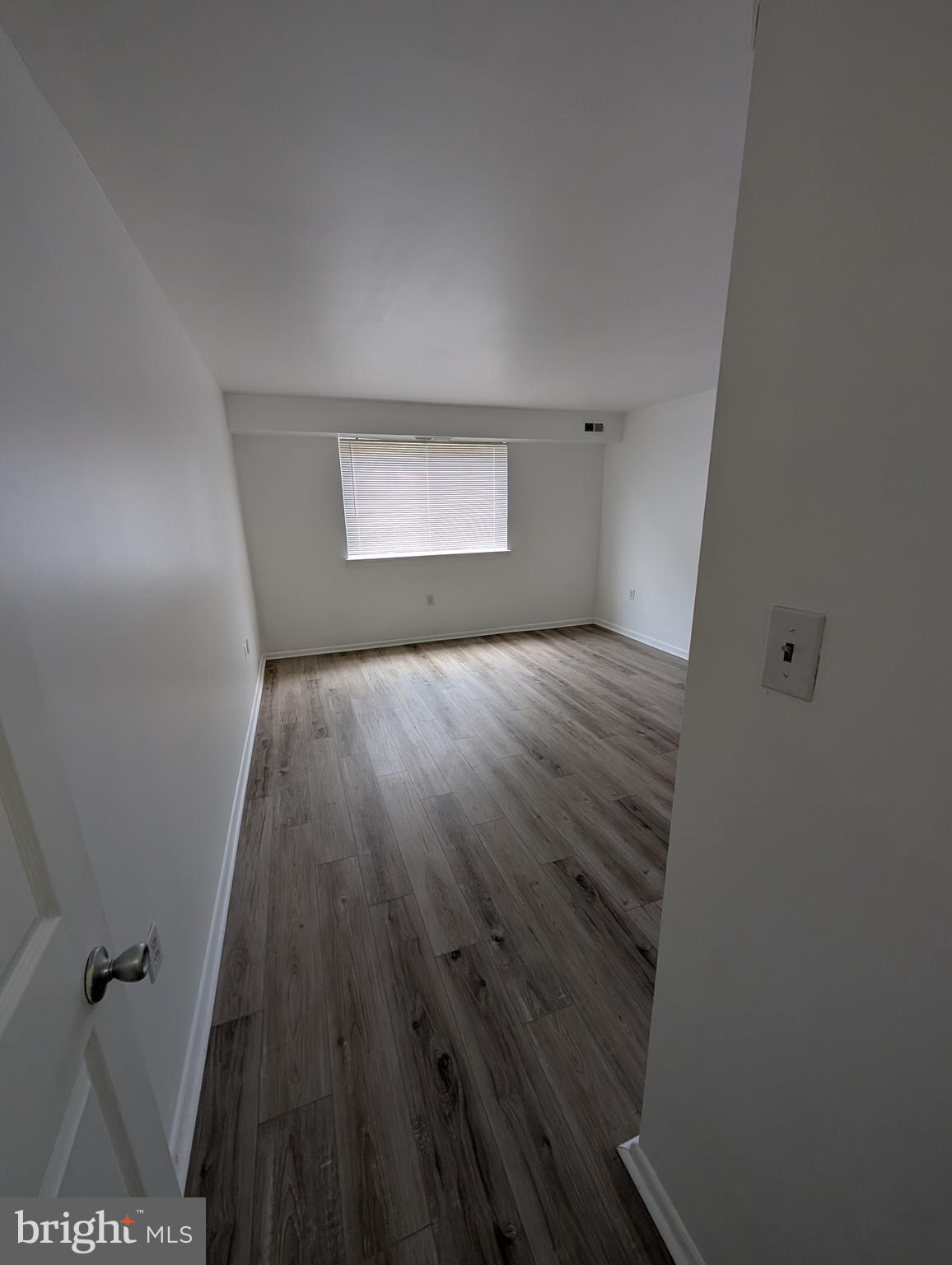 11402 Cherry Hill Road, Unit 103 Beltsville, MD 20705 - Photo 24 of 26 wooden floor in a hall with a window
