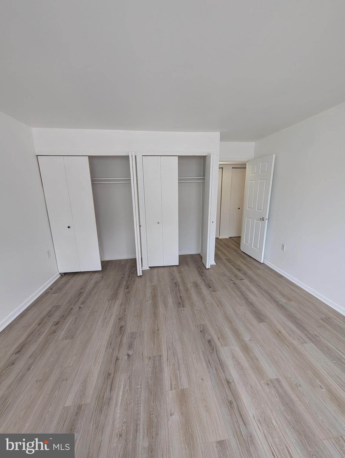 11402 Cherry Hill Road, Unit 103 Beltsville, MD 20705 - Photo 25 of 26 an empty room with wooden floor