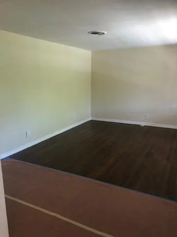 an empty room with wooden floor