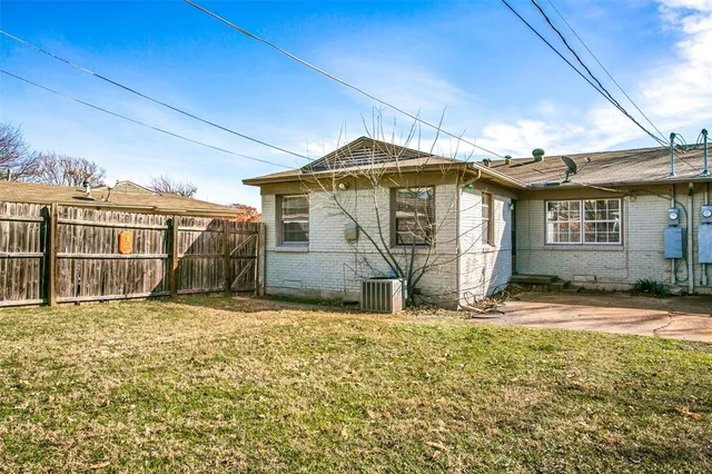 a view of a house with large windows and a yard