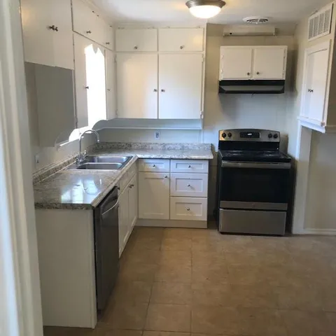 a kitchen with stainless steel appliances granite countertop a stove and a refrigerator