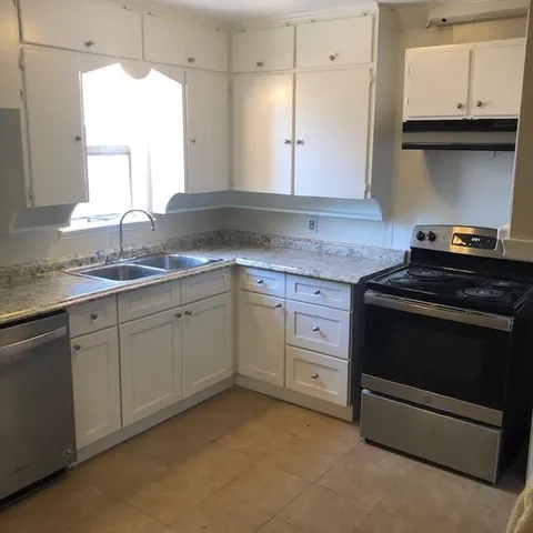 a kitchen with a stove and a sink