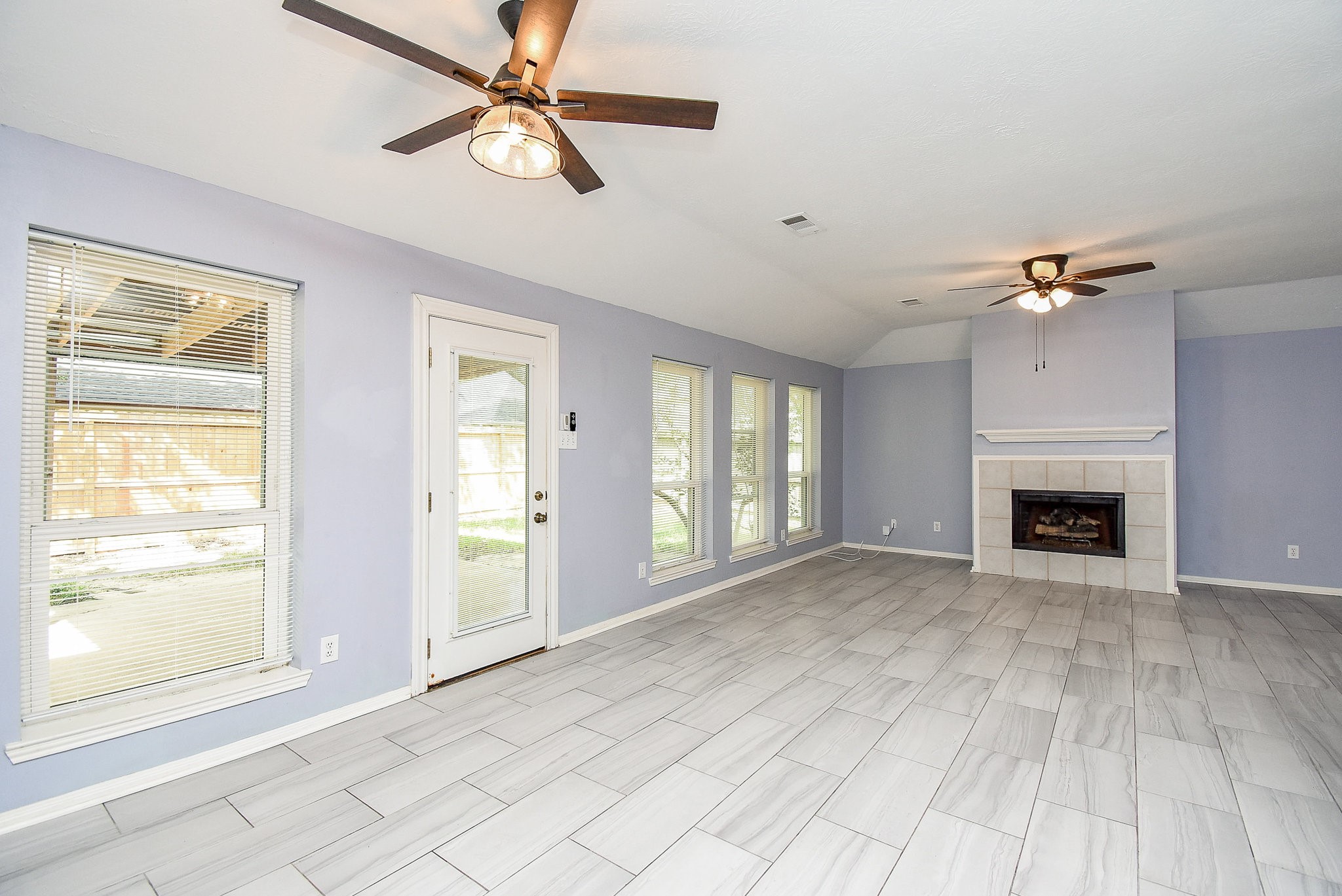 5431 Gosforth Drive Katy, TX 77449 - Photo 2 of 15 a view of an empty room with window and chandelier fan