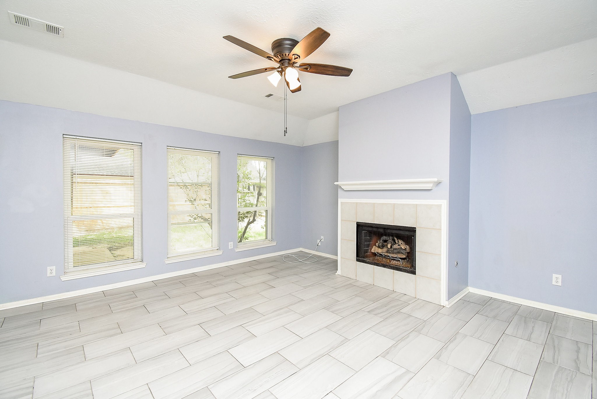 5431 Gosforth Drive Katy, TX 77449 - Photo 3 of 15 an empty room with windows and fireplace