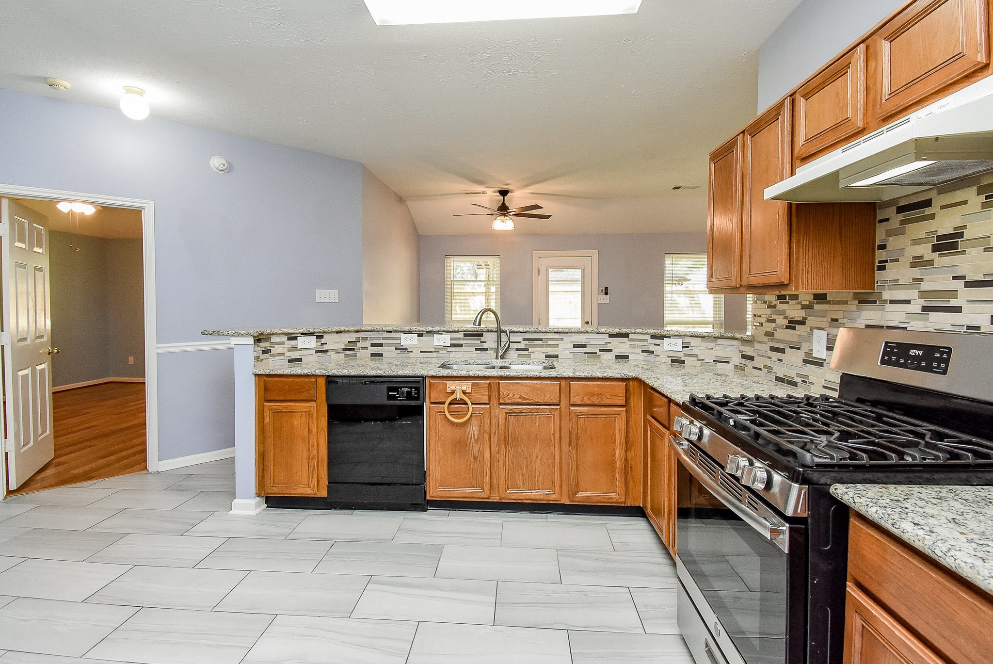 5431 Gosforth Drive Katy, TX 77449 - Photo 5 of 15 a kitchen with stainless steel appliances granite countertop a stove a sink and a refrigerator