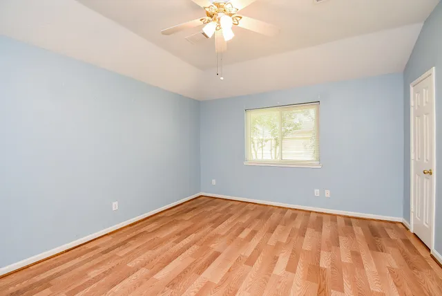 wooden floor in an empty room with a window