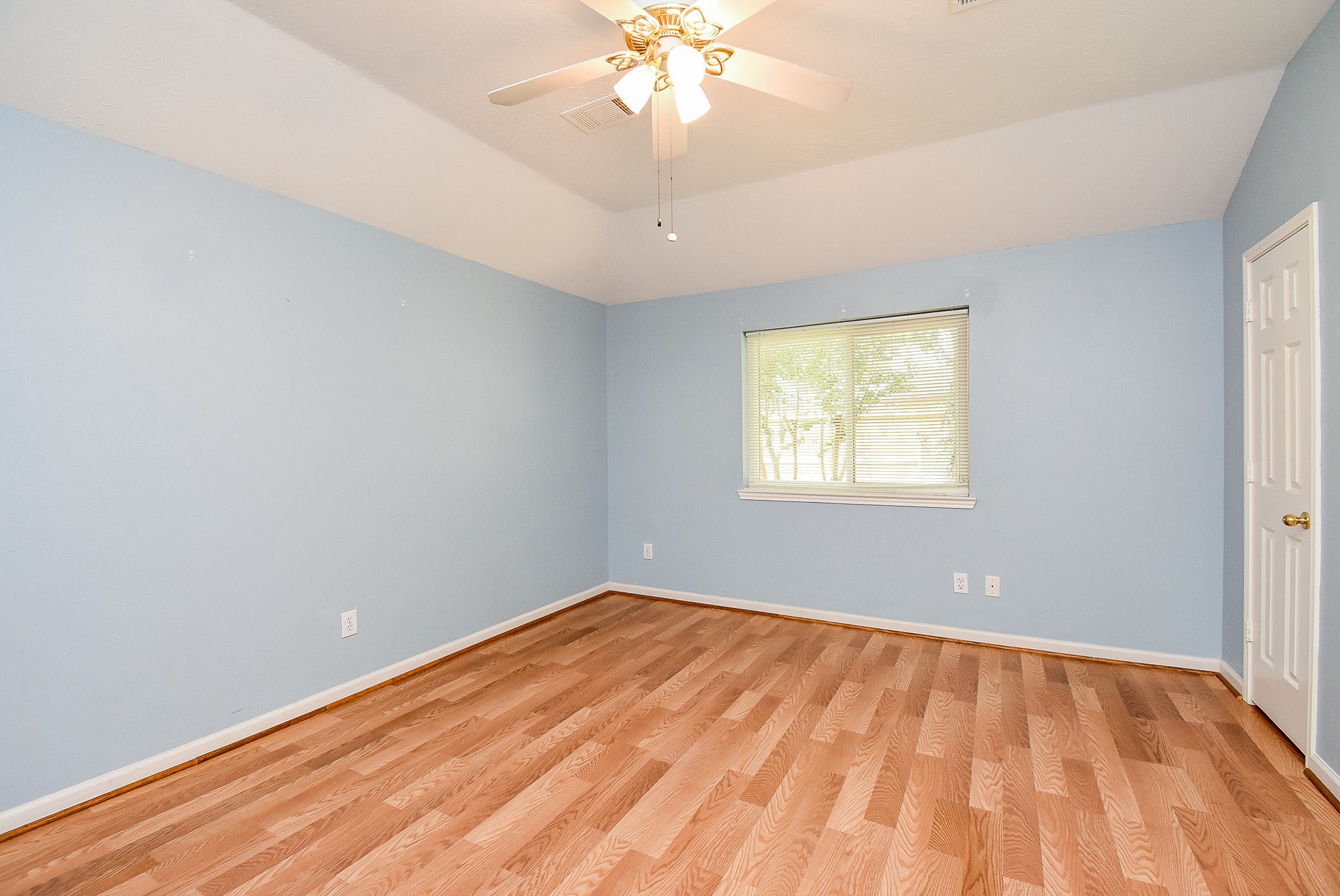 5431 Gosforth Drive Katy, TX 77449 - Photo 6 of 15 wooden floor in an empty room with a window