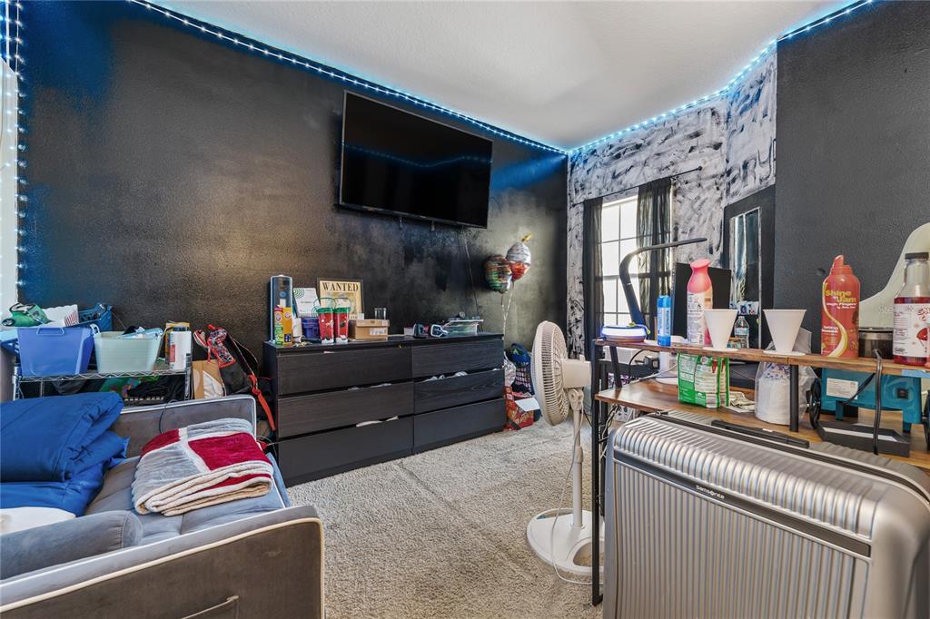 6039 Strada Isle Way Orlando, FL 32835 - Photo 14 of 24 a living room with furniture and a flat screen tv