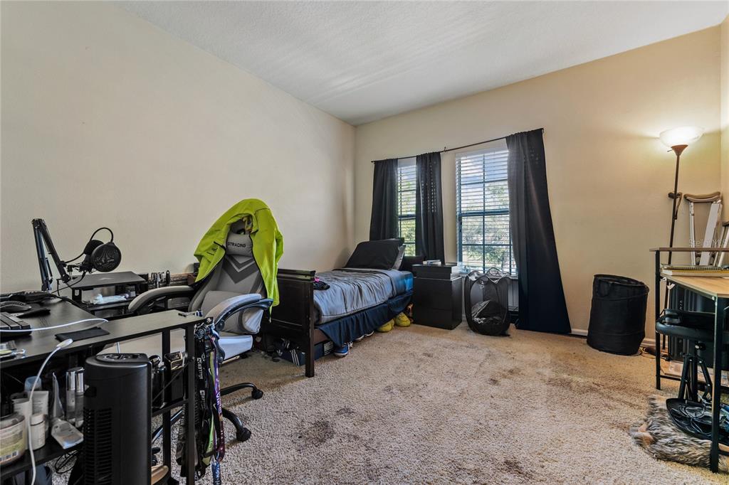 6039 Strada Isle Way Orlando, FL 32835 - Photo 15 of 24 a living room with furniture a window and gym equipment