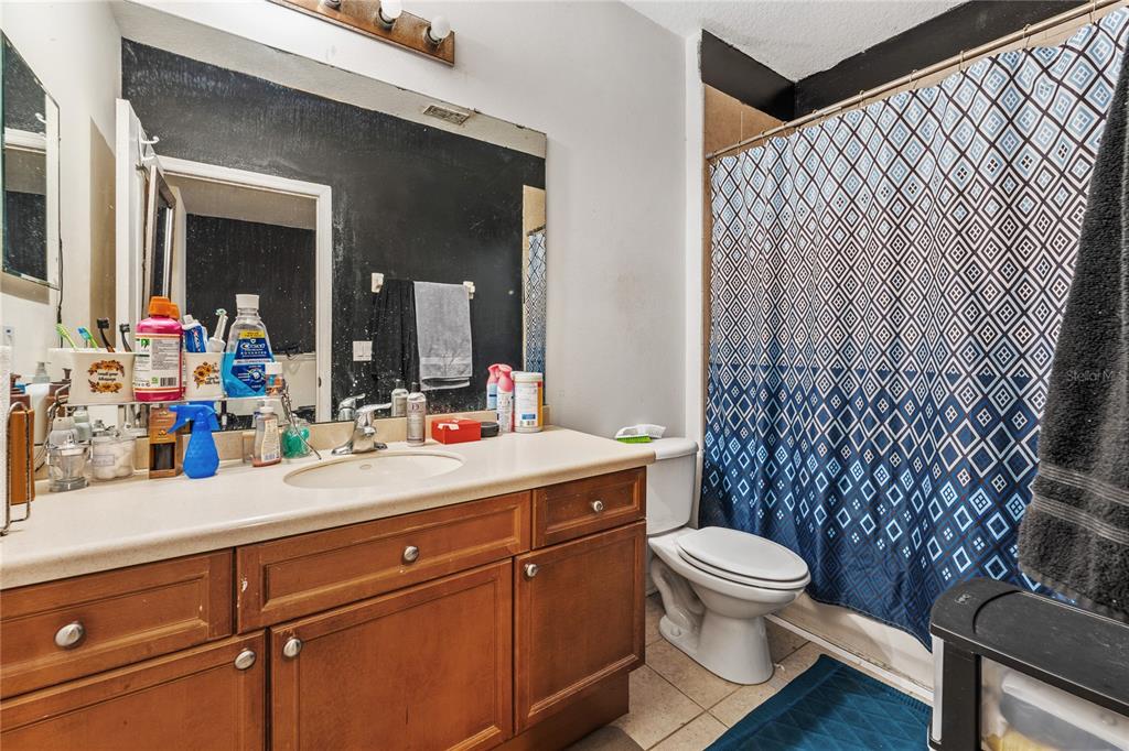 6039 Strada Isle Way Orlando, FL 32835 - Photo 18 of 24 a bathroom with a sink mirror vanity and toilet