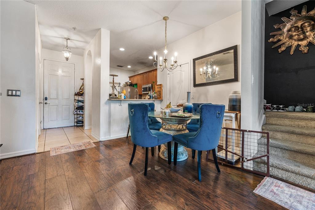 6039 Strada Isle Way Orlando, FL 32835 - Photo 6 of 24 a view of a dining room with furniture and chandelier