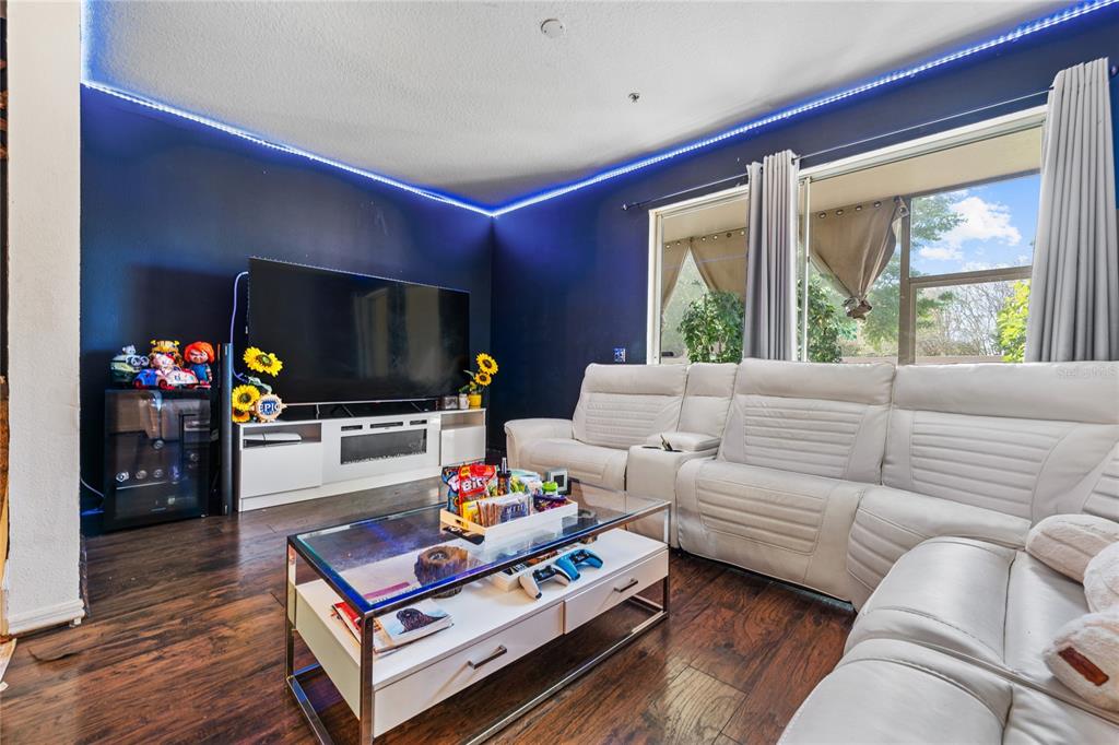 6039 Strada Isle Way Orlando, FL 32835 - Photo 7 of 24 a living room with furniture fireplace and flat screen tv