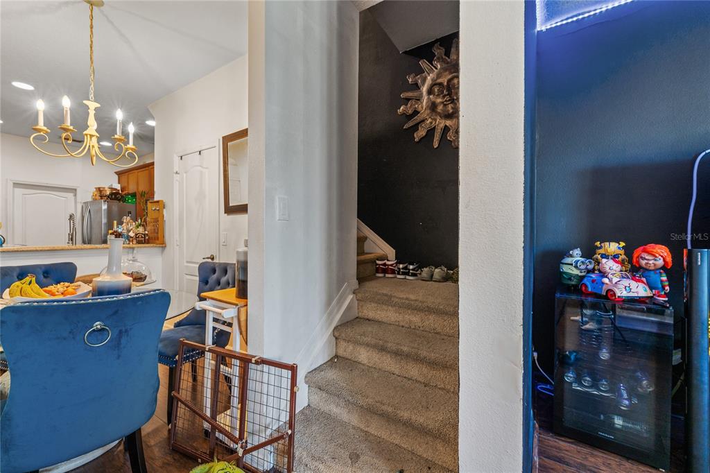 6039 Strada Isle Way Orlando, FL 32835 - Photo 8 of 24 a view of a dining room with a chandelier