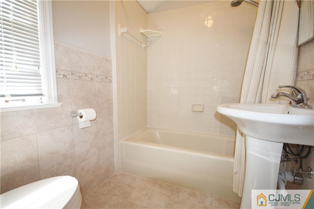 55 Milltown Road East Brunswick, NJ 08816 - Photo 12 of 18 a bathroom with a sink a toilet and shower