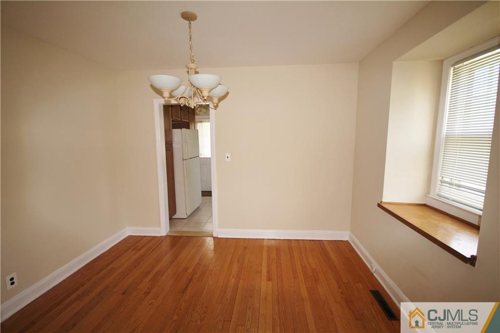 55 Milltown Road East Brunswick, NJ 08816 - Photo 4 of 18 a view of a room with wooden floor chandelier and a window