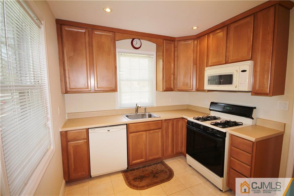 55 Milltown Road East Brunswick, NJ 08816 - Photo 5 of 18 a kitchen with a stove sink and cabinets
