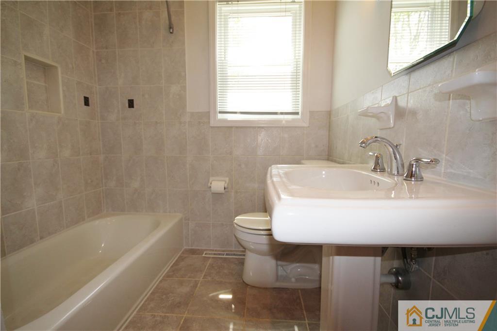 55 Milltown Road East Brunswick, NJ 08816 - Photo 8 of 18 a bathroom with a sink a toilet and bathtub