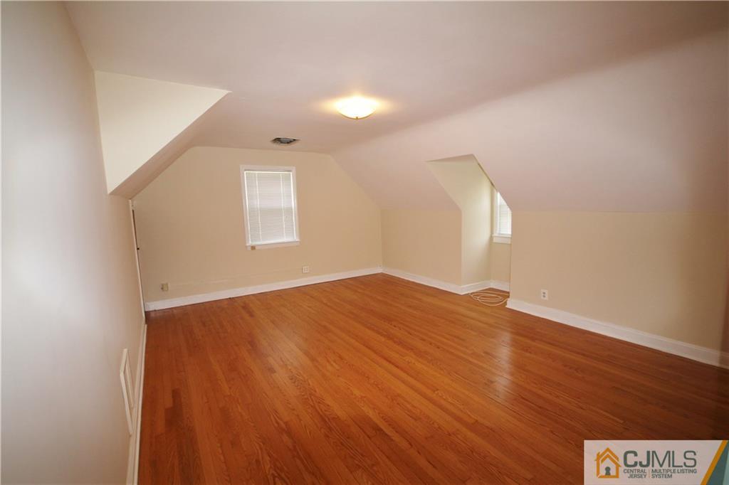 55 Milltown Road East Brunswick, NJ 08816 - Photo 10 of 18 an empty room with wooden floor and windows