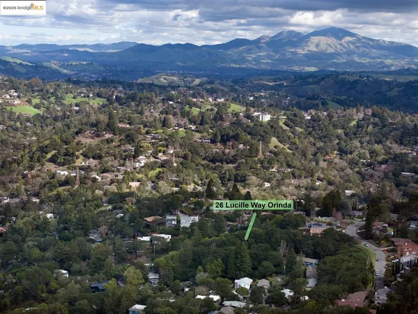 a big yard with lots of green space and house in the back
