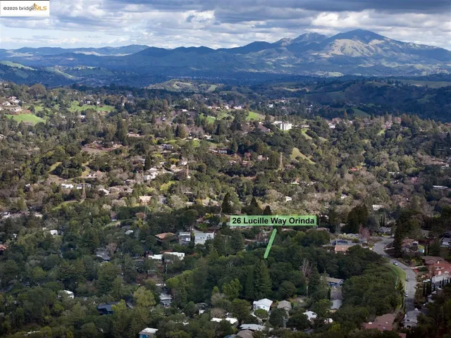 a big yard with lots of green space and house in the back