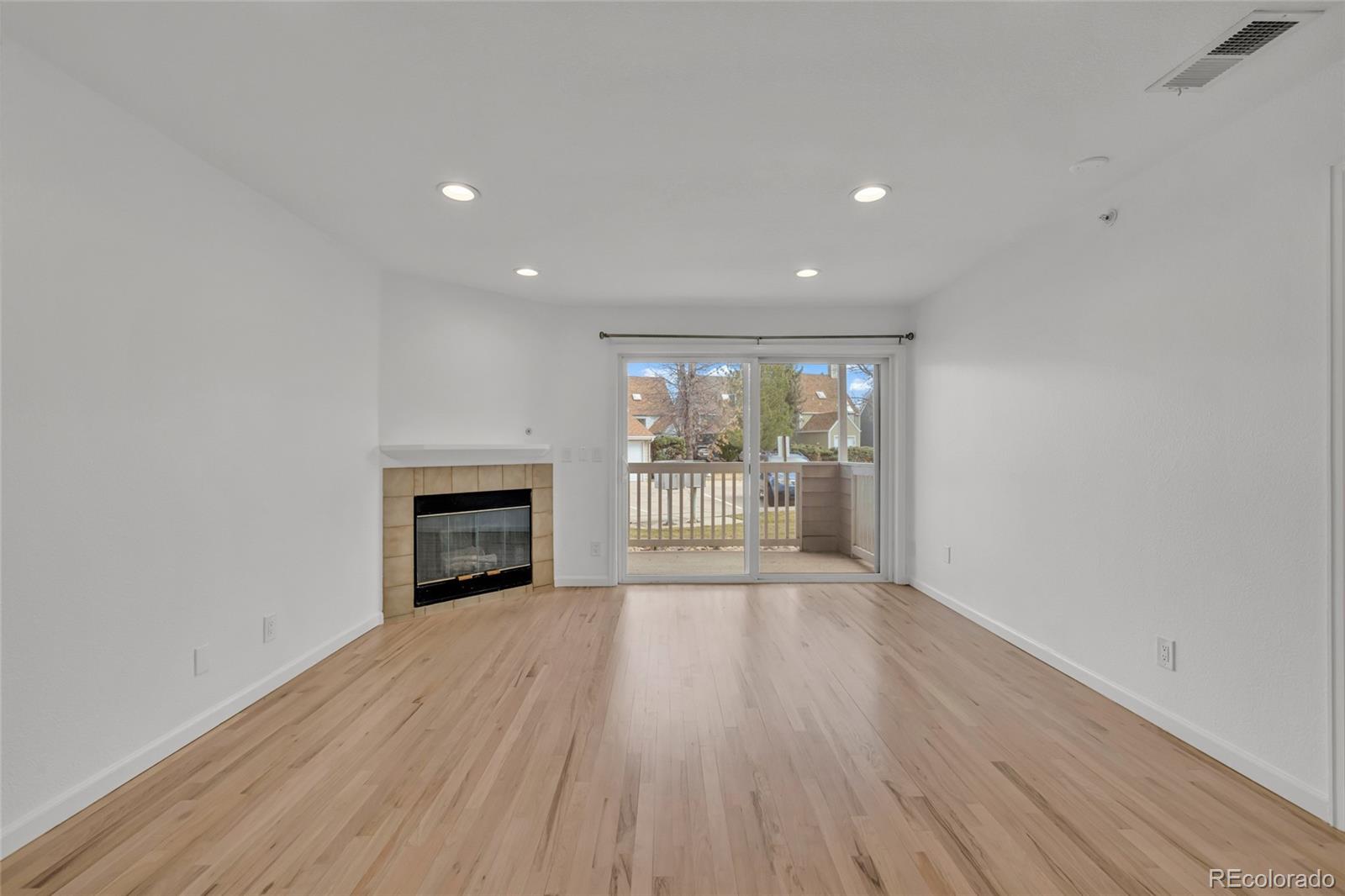 4870 Twin Lakes Road, Unit 1 Boulder, CO 80301 - Photo 11 of 26 a view of an empty room with wooden floor and a fireplace
