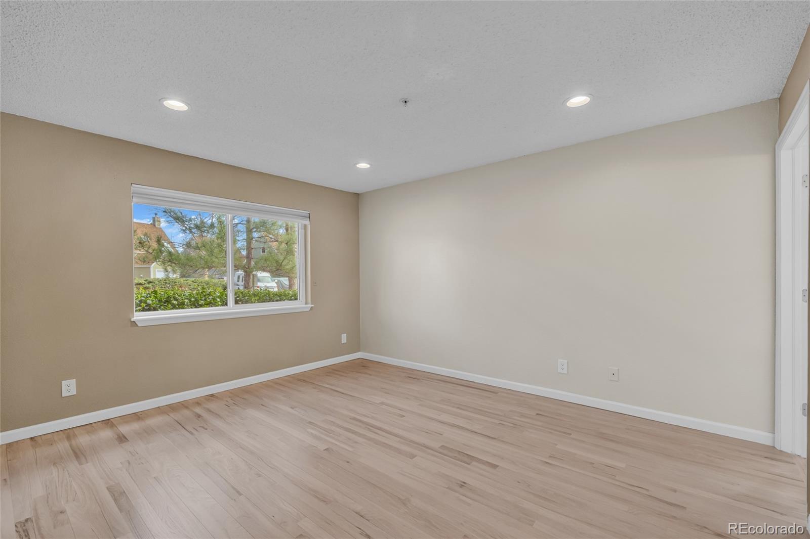 4870 Twin Lakes Road, Unit 1 Boulder, CO 80301 - Photo 16 of 26 a view of an empty room with wooden floor and a window