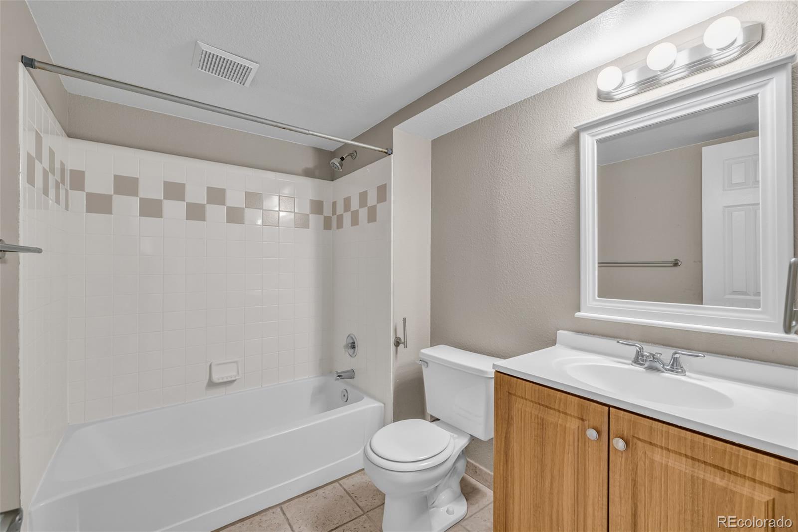 4870 Twin Lakes Road, Unit 1 Boulder, CO 80301 - Photo 18 of 26 a bathroom with a sink toilet vanity and shower
