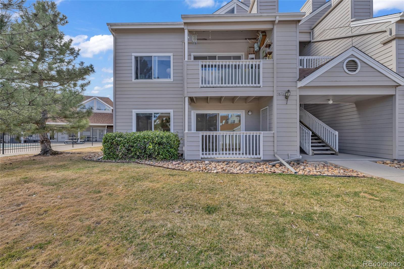 4870 Twin Lakes Road, Unit 1 Boulder, CO 80301 - Photo 2 of 26 a view of a house with a small yard and large tree