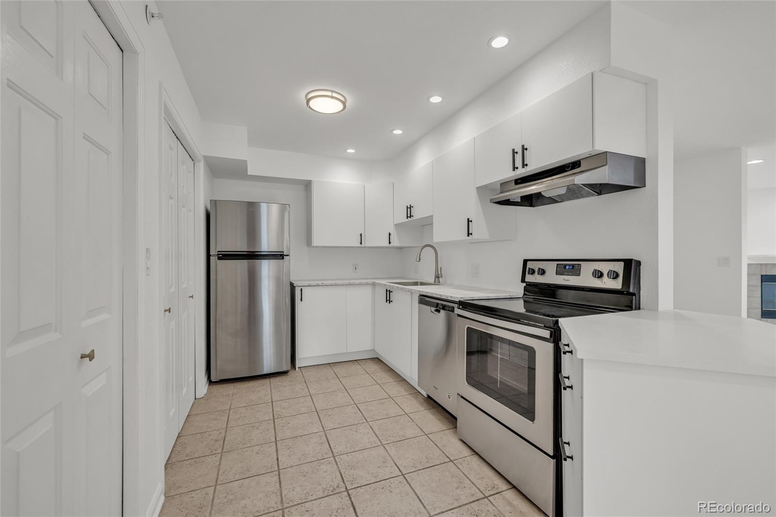 4870 Twin Lakes Road, Unit 1 Boulder, CO 80301 - Photo 6 of 26 a kitchen with a stove a refrigerator and a sink