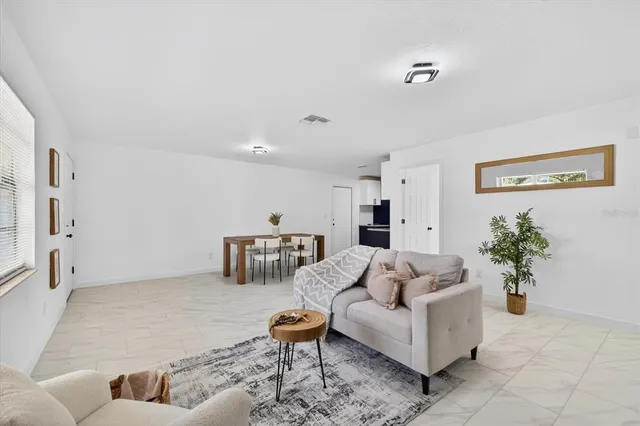 a living room with furniture and flowers
