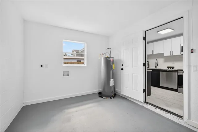 a view of kitchen with refrigerator and window