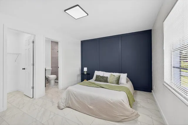 a bedroom with a bed and cabinets