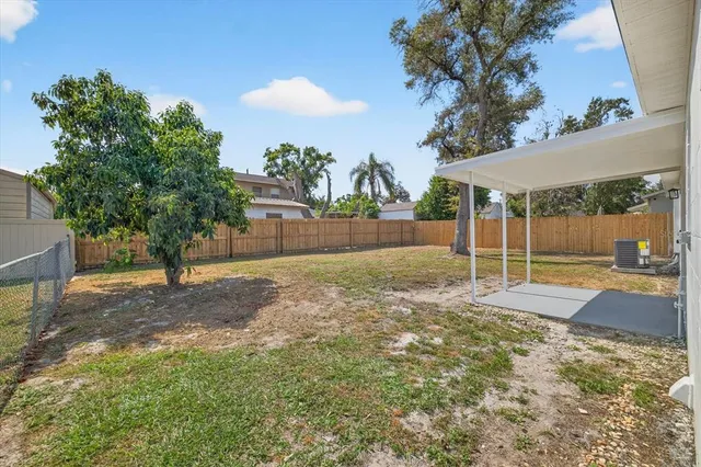 a view of a yard with a tree