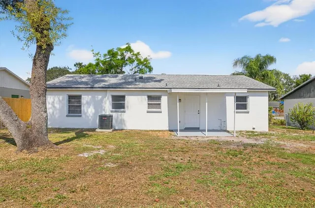 a view of a house with a tree in the background