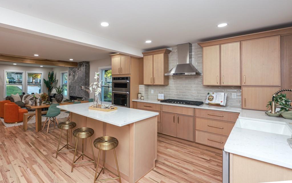2566 Creekwood Terrace Decatur, GA 30030 - Photo 11 of 49 a large kitchen with kitchen island a sink a stove a dining table and chairs