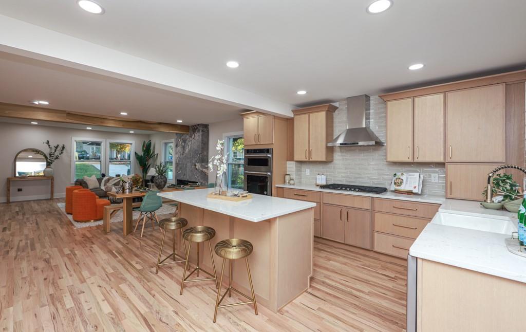 2566 Creekwood Terrace Decatur, GA 30030 - Photo 12 of 49 a large kitchen with stainless steel appliances granite countertop a stove a sink a refrigerator and white cabinets with wooden floor