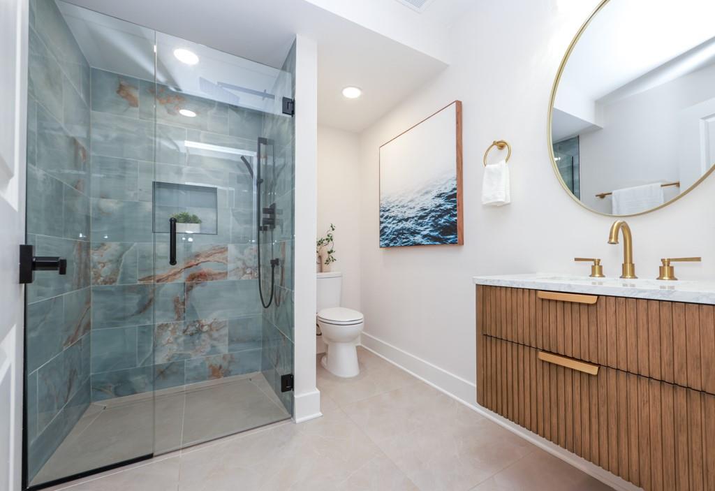 2566 Creekwood Terrace Decatur, GA 30030 - Photo 17 of 49 a bathroom with a toilet sink and mirror